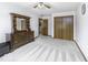 Light-filled bedroom features neutral carpet, dresser, and an adjacent closet at 7741 Long Branch Dr, Indianapolis, IN 46259