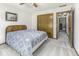 Bedroom featuring neutral carpet, a ceiling fan, and a bed with a patterned comforter at 7741 Long Branch Dr, Indianapolis, IN 46259