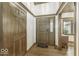Warm and inviting foyer with hardwood floors, wood trim, and a view of the front door at 7741 Long Branch Dr, Indianapolis, IN 46259
