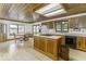Spacious kitchen with wood cabinets, center island, and a dining area bathed in natural light at 7741 Long Branch Dr, Indianapolis, IN 46259