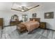 Warm and inviting main bedroom featuring a trey ceiling, ceiling fan and sitting area at 7741 Long Branch Dr, Indianapolis, IN 46259