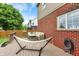 Back deck with a hammock, outdoor seating, and brick exterior creating a perfect spot for relaxation and entertainment at 8030 Parcrest Ct, Indianapolis, IN 46259