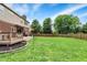 Sprawling backyard featuring a well-manicured lawn, deck, and mature trees creating a serene outdoor oasis at 8030 Parcrest Ct, Indianapolis, IN 46259