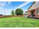 Spacious backyard with a large green lawn and a view of the house, featuring a deck and awning at 8030 Parcrest Ct, Indianapolis, IN 46259