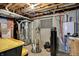 Basement utility area with exposed pipes, water heater, sump pump, and other mechanical systems, showcasing functional infrastructure at 8030 Parcrest Ct, Indianapolis, IN 46259