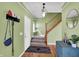 Welcoming foyer with hardwood floors, staircase, and a modern accent cabinet at 8030 Parcrest Ct, Indianapolis, IN 46259
