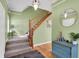 Spacious foyer with hardwood floors, staircase, modern light fixture, and accent furniture at 8030 Parcrest Ct, Indianapolis, IN 46259