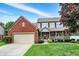 Charming two-story home features a brick facade, covered porch, well-maintained lawn and an attached two car garage at 8030 Parcrest Ct, Indianapolis, IN 46259