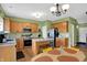 Spacious kitchen featuring wooden cabinets, a center island, stainless steel appliances, and a view of the backyard at 8030 Parcrest Ct, Indianapolis, IN 46259