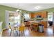 Open concept kitchen featuring wooden cabinets, a breakfast bar, stainless steel appliances, and a dining area at 8030 Parcrest Ct, Indianapolis, IN 46259