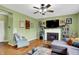 Living room featuring hardwood floors, a fireplace with shelving, natural light, and comfortable seating at 8030 Parcrest Ct, Indianapolis, IN 46259