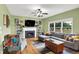 Cozy living room features a fireplace with built-in shelving, large windows, and comfortable seating on hardwood floors at 8030 Parcrest Ct, Indianapolis, IN 46259