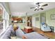 Inviting living room featuring hardwood floors, neutral paint, a comfortable sofa, and a view into the adjacent kitchen at 8030 Parcrest Ct, Indianapolis, IN 46259