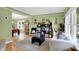 Stylish living room with hardwood floors, art, black shelving units, and an adjacent dining area at 8030 Parcrest Ct, Indianapolis, IN 46259