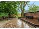 Backyard oasis featuring a spacious deck and multiple seating areas and a fire pit at 8140 Springwater W Dr, Indianapolis, IN 46256