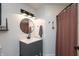 Well-lit bathroom featuring a modern vanity, round mirror, and stylish shower curtain at 8140 Springwater W Dr, Indianapolis, IN 46256