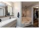 Bathroom with double sink vanity, soaking tub, and a door leading to the walk-in closet at 8140 Springwater W Dr, Indianapolis, IN 46256