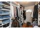 Organized walk-in closet with shelves and hanging rods for optimal storage at 8140 Springwater W Dr, Indianapolis, IN 46256