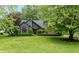Charming exterior view of a well-maintained home with beautiful landscaping and mature trees at 8140 Springwater W Dr, Indianapolis, IN 46256
