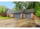 Spacious two-car garage with driveway and brick accents on the exterior at 8140 Springwater W Dr, Indianapolis, IN 46256