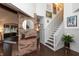 Elegant hallway with a brick accent wall and staircase leading to the upper level at 8140 Springwater W Dr, Indianapolis, IN 46256