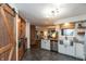Open kitchen design with stainless appliances, farmhouse sink, and view of living space at 8140 Springwater W Dr, Indianapolis, IN 46256