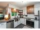 Well-lit kitchen features granite counters, stainless steel appliances, and a farmhouse sink at 8140 Springwater W Dr, Indianapolis, IN 46256