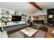 Spacious living room with a vaulted ceiling, modern shelving, and an open layout to the dining area at 8140 Springwater W Dr, Indianapolis, IN 46256