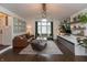 Bright and open living room with a vaulted ceiling, large window, and modern decor at 8140 Springwater W Dr, Indianapolis, IN 46256