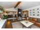 Cozy living room with a fireplace, hardwood floors, and an open layout to the kitchen at 8140 Springwater W Dr, Indianapolis, IN 46256