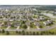 Wide aerial view of The Landings at Sugarcreek neighborhood, showing community homes and surrounding pond at 8663 N Commonview Dr, McCordsville, IN 46055