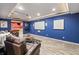 Finished basement with cozy seating, home theater screen, and access to a billiards room at 8663 N Commonview Dr, McCordsville, IN 46055