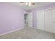 Lilac painted bedroom features a sliding door closet, and neutral carpet, providing a welcoming space at 8663 N Commonview Dr, McCordsville, IN 46055