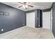 This bedroom has a ceiling fan, closet, door, and plush carpet, and is painted navy blue at 8663 N Commonview Dr, McCordsville, IN 46055