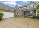 Charming brick and siding home boasts a spacious driveway, attached garage, and lovely landscaping at 8663 N Commonview Dr, McCordsville, IN 46055