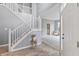 Bright foyer with a staircase and light wood floors create a welcoming and stylish entrance to the home at 8663 N Commonview Dr, McCordsville, IN 46055