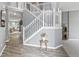 Bright foyer with beautiful staircase and light wood floors, creating an inviting and stylish entryway at 8663 N Commonview Dr, McCordsville, IN 46055