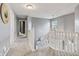 Bright hallway with neutral gray walls and plush carpeting leads to the second floor at 8663 N Commonview Dr, McCordsville, IN 46055