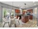 Eat-in kitchen featuring modern lighting, stainless appliances, and patio access for entertaining at 8663 N Commonview Dr, McCordsville, IN 46055