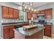 Kitchen boasts wooden cabinets, stainless appliances, stone countertops, and a functional island at 8663 N Commonview Dr, McCordsville, IN 46055