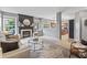 Open-concept living room with a decorative fireplace flowing into the kitchen space at 8663 N Commonview Dr, McCordsville, IN 46055