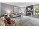 Comfortable living room featuring a decorative fireplace, large windows, and stylish furnishings at 8663 N Commonview Dr, McCordsville, IN 46055