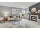 Comfortable living room featuring a decorative fireplace, large windows, and stylish furnishings at 8663 N Commonview Dr, McCordsville, IN 46055