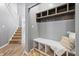 Mudroom with bench, overhead storage, and hooks offers practical space for entry essentials and organization at 8663 N Commonview Dr, McCordsville, IN 46055