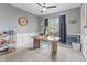 Bright home office features wainscoting, contemporary lighting, and neutral tones for a productive workspace at 8663 N Commonview Dr, McCordsville, IN 46055