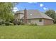 Spacious backyard featuring a well-maintained lawn and attractive landscaping, enhancing this home's outdoor appeal at 9175 Lakewind Dr, Indianapolis, IN 46256