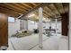 Unfinished basement featuring exposed beams, support pillars and workout equipment at 9175 Lakewind Dr, Indianapolis, IN 46256