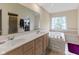 Bright bathroom featuring double sinks, soaking tub and walk-in closet at 9175 Lakewind Dr, Indianapolis, IN 46256