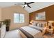 Vaulted ceiling bedroom with modern decor, large window, and ceiling fan at 9175 Lakewind Dr, Indianapolis, IN 46256