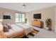 Serene bedroom with natural light, neutral tones, and a ceiling fan for added comfort at 9175 Lakewind Dr, Indianapolis, IN 46256